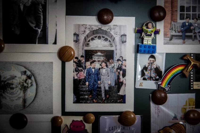 A photo of Henry Li and his husband Edgar Ng hanging on a wall in their Hong Kong apartmen