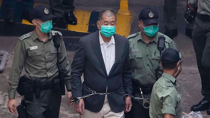 Hong Kong activist Jimmy Lai is seen in handcuffs in 2020