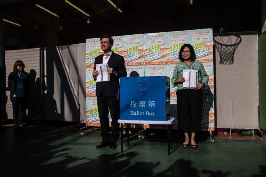 Hong Kong city leader John Lee (centre L) said this year's election was 'the last piece of the puzzle to implement the principle of patriots ruling Hong Kong'