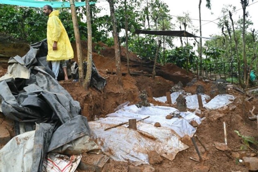 Graves are covered in plastic sheets at a burial site in Wayanad in southern India's Keral