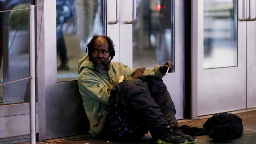 NEW YORK, NEW YORK - NOVEMBER 30: A homeless man sits at Times Square on November 30, 2022 in New York City. New York City Mayor Eric Adams rolled out a plan to allow mentally ill homeless people to be hospitalized against their will. (Photo by Leonardo Munoz/VIEWpress)