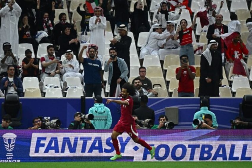 Qatar's forward Akram Afif celebrates after scoring his team's third