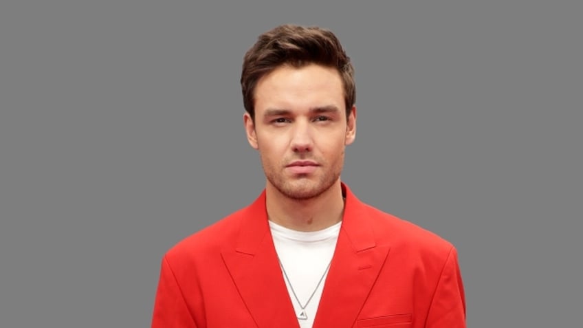 Liam Payne wears red blazer in portrait photos.