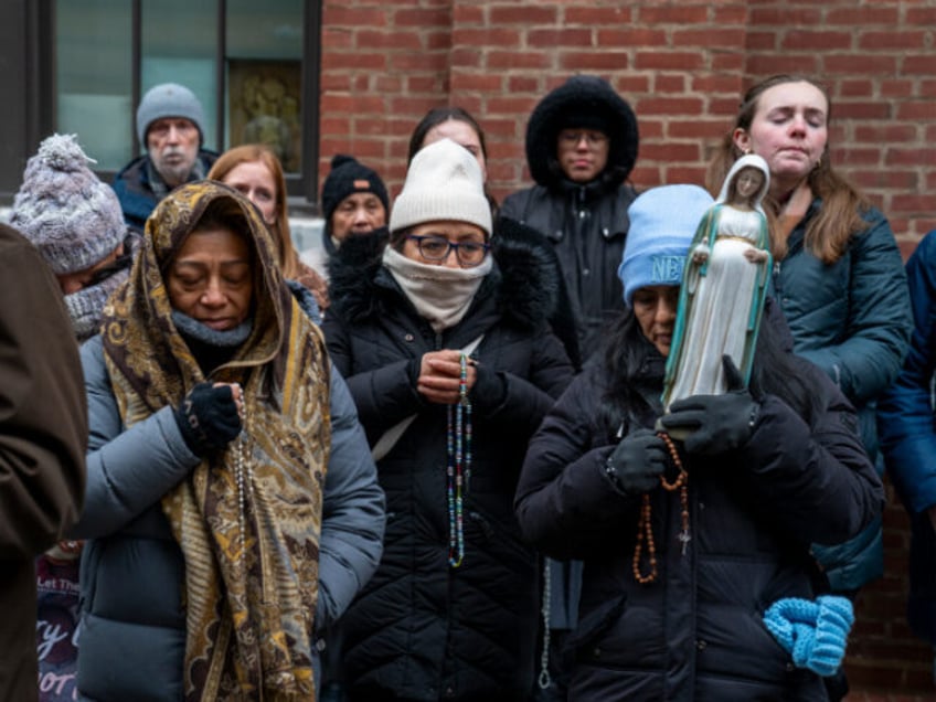 Anti-abortion activists hold their rosaries during a prayer in front of a Planned Parentho