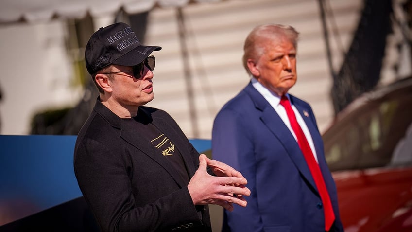 Musk and Trump outside White House with red Tesla