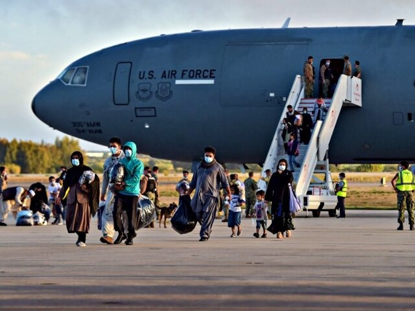 Refugees disembark from a US air force aircraft after an evacuation flight from Kabul at t