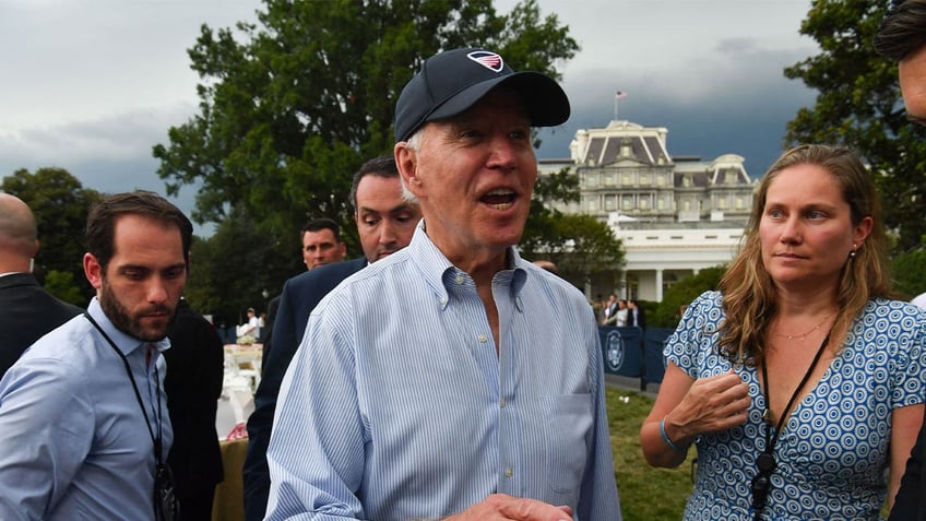 Joe Biden talks to reporters at White House Congressional Picnic.