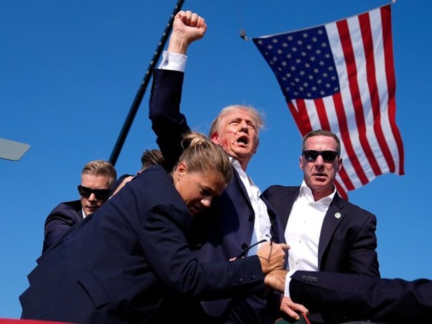 FILE - Republican presidential candidate former President Donald Trump is surrounded by U.