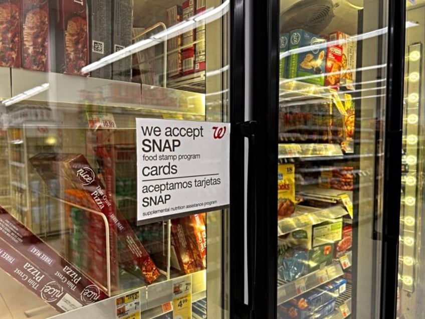 Bilingual sign on door of frozen food aisle, We accept SNAP food stamp cards, Walgreens, Q