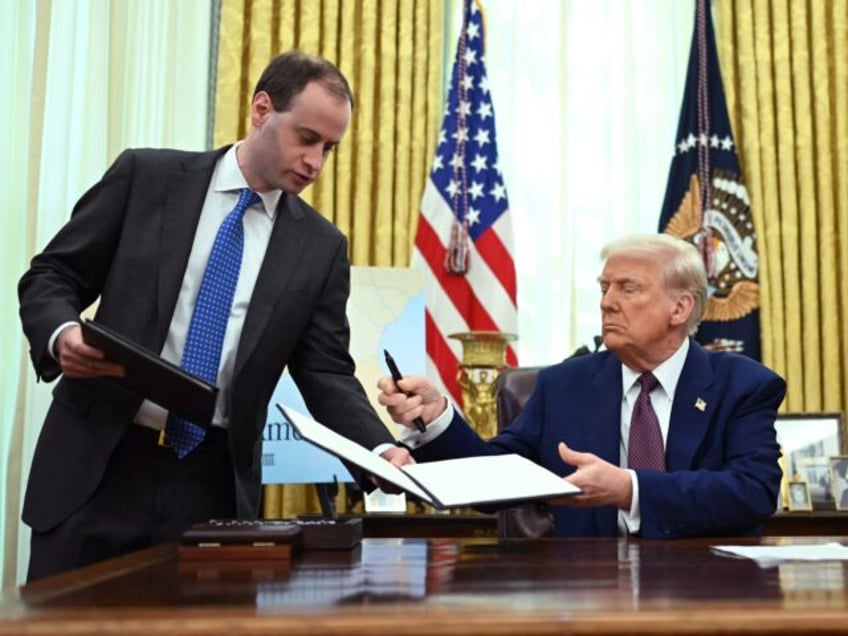 US President Donald Trump signs executive orders in the Oval Office of the White House in