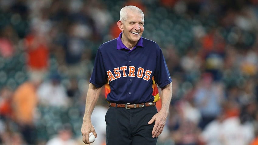 Jim McIngvale smiles before throwing a ball