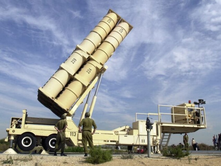 Israeli soldiers demonstrate the operation of the Arrow anti-missile mobile launcher at th