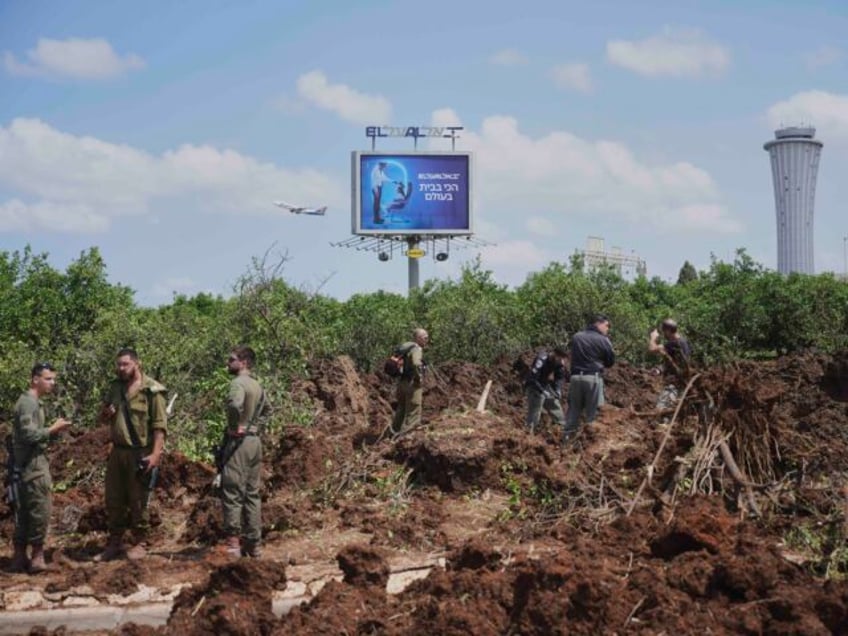 Israeli security forces inspect the site where the Israeli military said a projectile fire