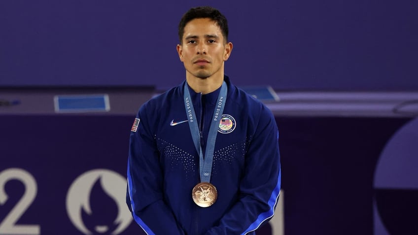 Bronze medalist Victor Montalvo of Team USA stands on the podium during the Breaking B-Boys medal ceremony at the Olympic Games in Paris on Aug. 10, 2024.