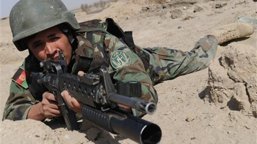 An Afghan National Army (ANA) soldier is alert during an exercise near a military base in Gereshk city of Helmand province on Wednesday Feb. 17, 2010. ( AP Photo/Massoud Hossaini, Pool)