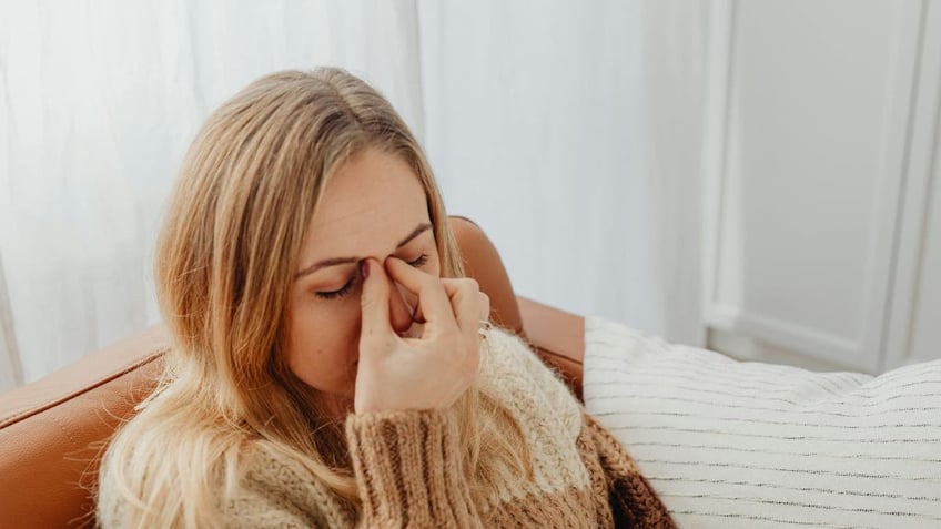 A woman with a sinus infection.