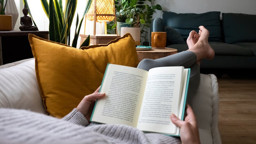 Person reading on couch 