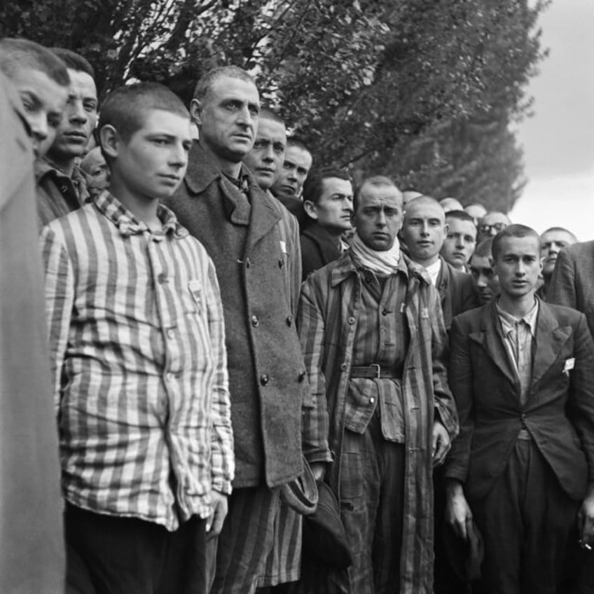 French prisoners at the Dachau concentration camp near Munich observe a minute's silence a