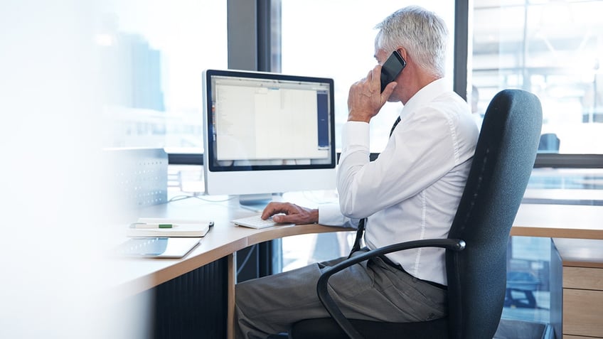 business man talking on phone in office