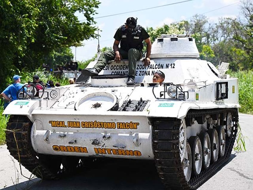 An armored vehicle drives near the Tocoron prison after authorities seized control of the