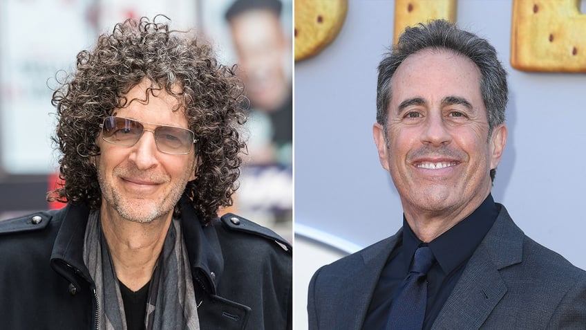 Howard Stern in a black jacket and scarf soft smiles outside split Jerry Seinfeld in a blue suit smiles on the carpet