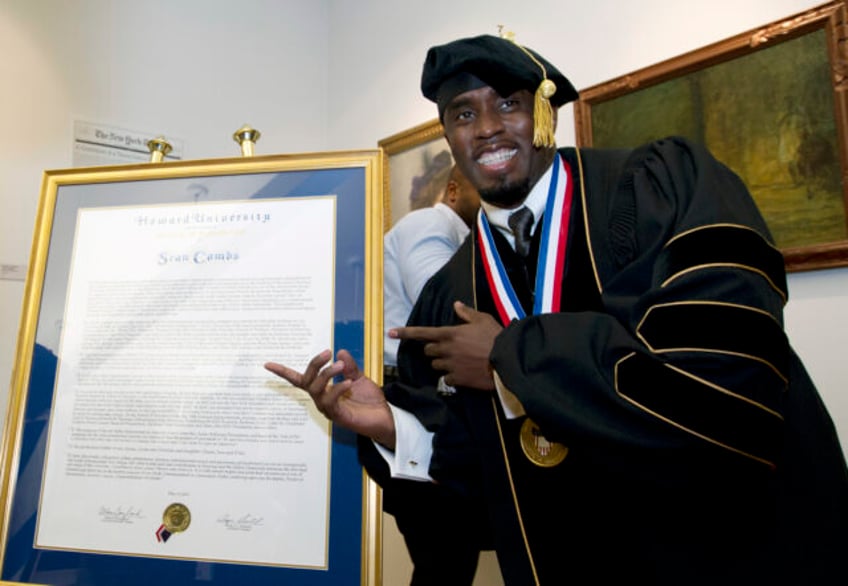 FILE - Entertainer and entrepreneur Sean Combs poses next to his honorary degree of Doctor