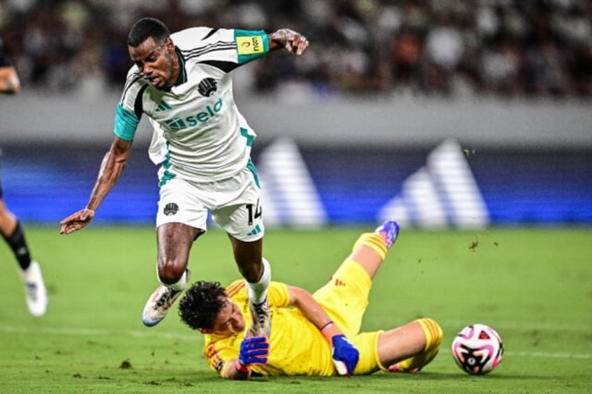 Newcastle's Alexander Isak is challenged by Yokohama goalkeeper Hiroki Iikura in Tokyo