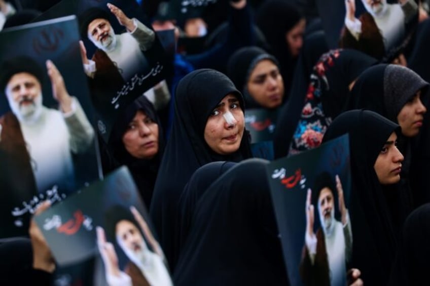 Women mourn the death of Iran's president Ebrahim Raisi at Valiasr Square in Tehran