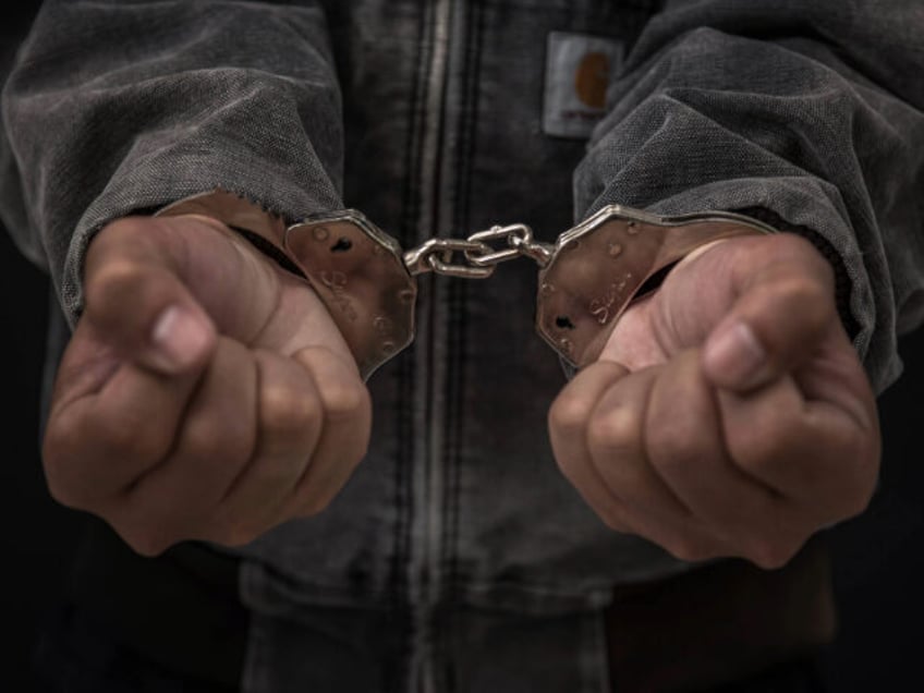 Upset handcuffed man imprisoned for financial crime, punished for serious fraud - stock ph