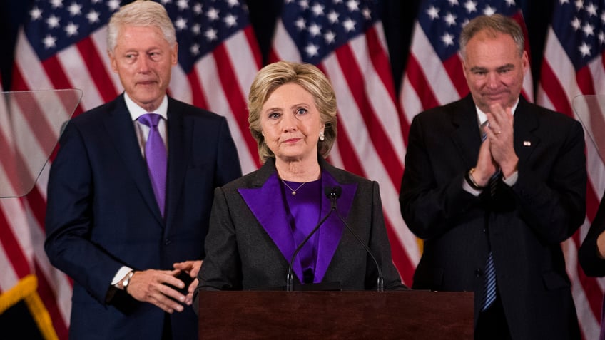 Hillary Clinton, center, with Bill Clinton and Tim Kaine behind her