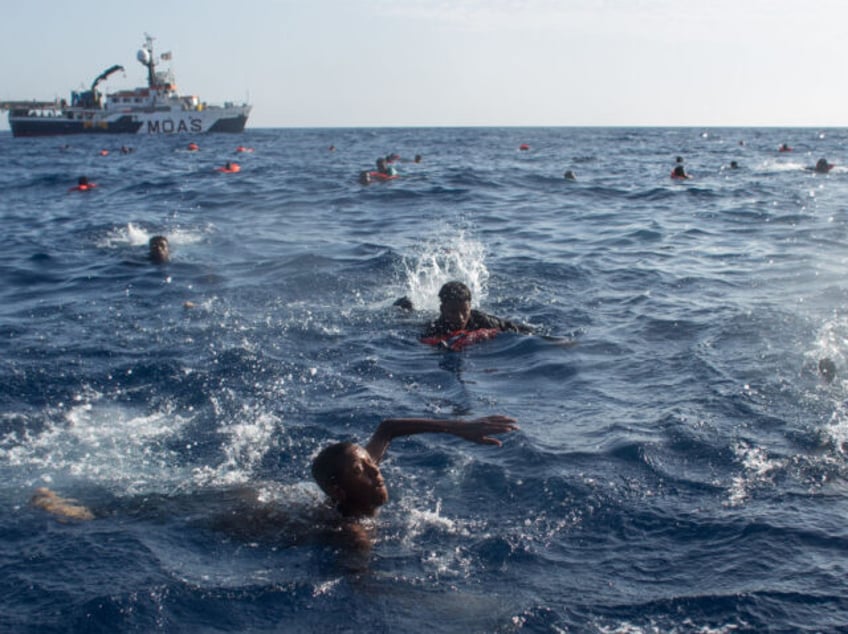 LAMPEDUSA, ITALY - MAY 24: Refugees and migrants are seen swimming and yelling for assitance from crewmembers from the Migrant Offshore Aid Station (MOAS) 'Phoenix' vessel after a wooden boat bound for Italy carrying more than 500 people capsized on May 24, 2017 off Lampedusa, Italy. The Migrant Offshore Aid …