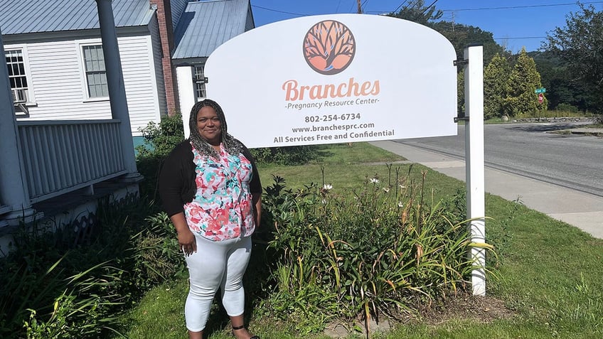 woman in front of sign