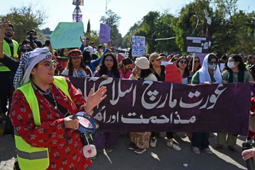 Women activists take part in Aurat March, a demonstration rally, to mark the International