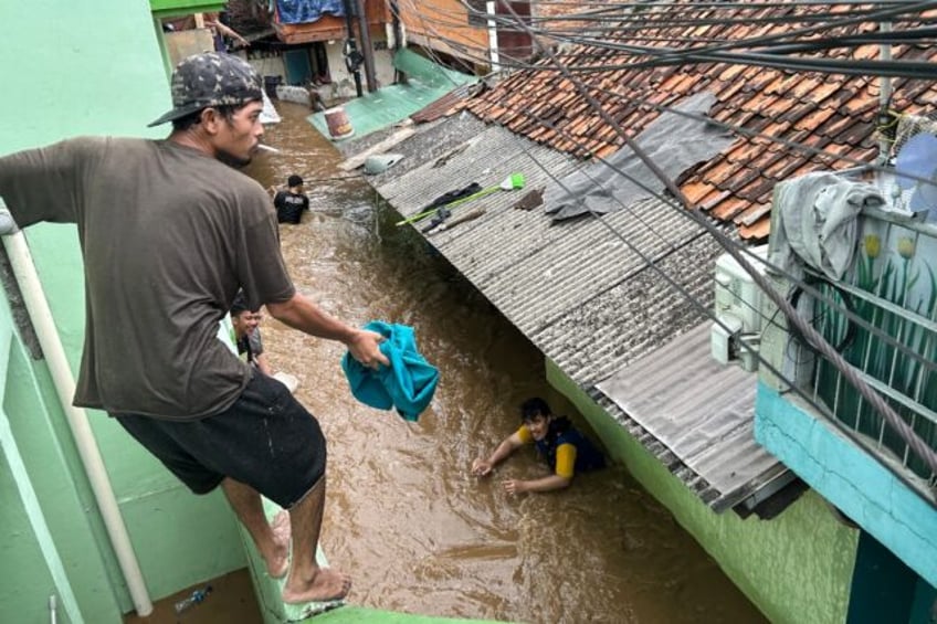 Residents look to evacuate during severe flooding in Indonesian capital Jakarta