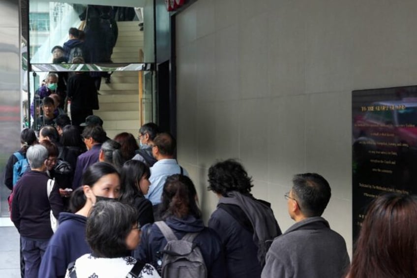 People queue to enter the Methodist International Church to pay their respects to Shiu Ka-