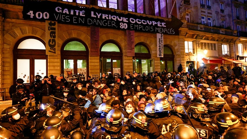 Police, protesters outside Paris theater where migrants are squatting