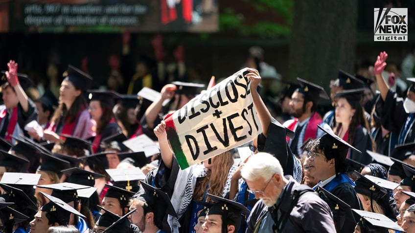 Yale graduates protest the Hamas-Israel war while holding signs