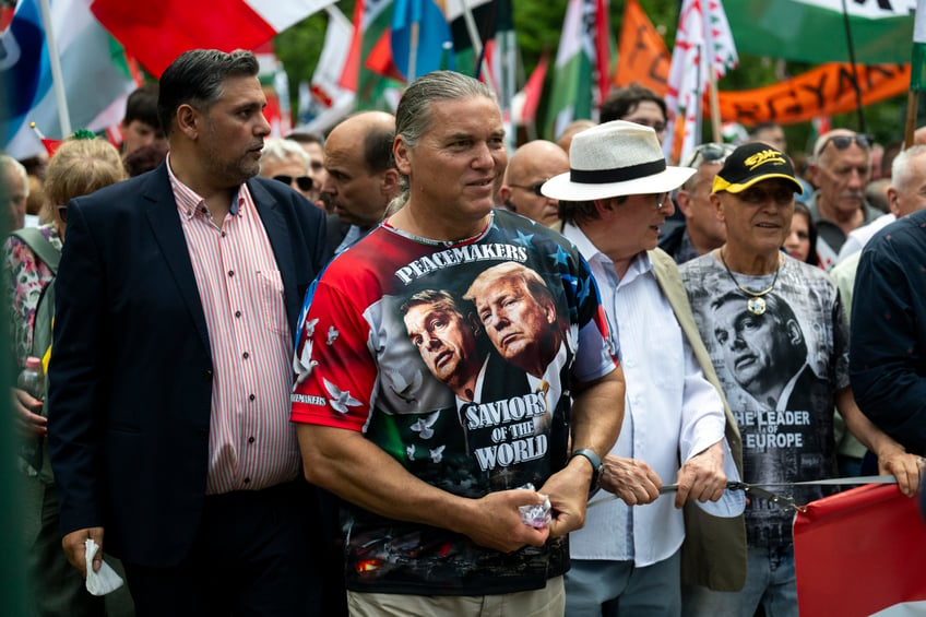 A man wearing a T-shirt showing Viktor Orbán and Donald Trump, attends a "peace march" in support of Prime Minister Viktor Orbán and his party in Budapest, Hungary on Saturday, June 1, 2024. Orbán, whose 14 years in power make him the European Union's longest serving leader, has focused his campaign for the June 9 European Parliament elections on the war in Ukraine, portraying his domestic and international opponents as warmongers who seek to involve Hungary directly in the conflict. (AP Photo/Denes Erdos)