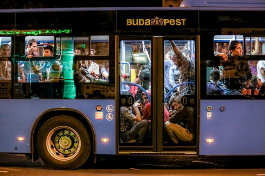 Hundreds of migrants depart in buses from Budapest Keleti railway station in Budapest, Hun