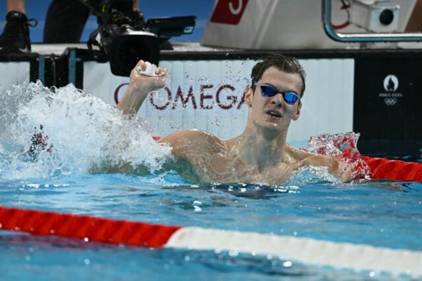 Hungary's Hubert Kos celebrates after winning the final of the men's 200m backstroke