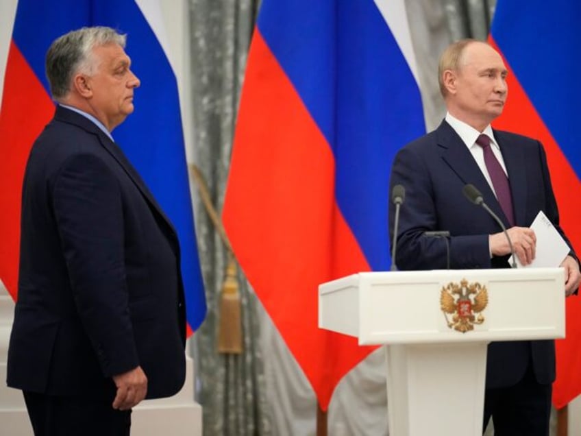 Russian President Vladimir Putin, right, and Hungarian Prime Minister Viktor Orban attend