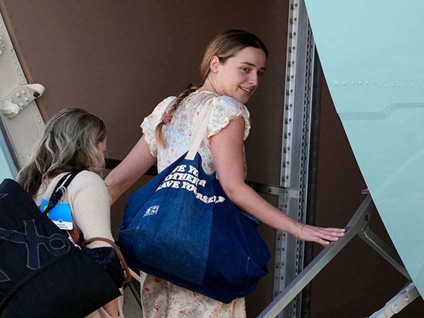 President Joe Biden's granddaughter Finnegan Biden, right, boards Air Force at Andrews Air Force Base, Md., Wednesday, June 12, 2024. President Biden is headed to Italy for the G7 summit. (AP Photo/Alex Brandon)