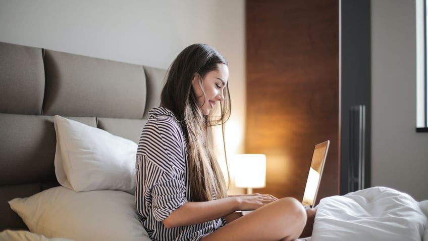 woman with laptop in bed