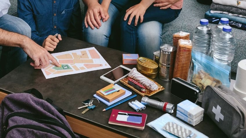 Family goes over emergency supply and evacuation plan