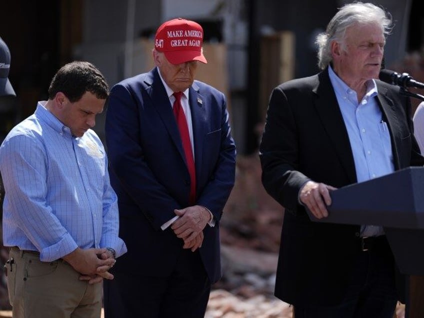 Republican presidential nominee former President Donald Trump listens as Rev. Franklin Gra