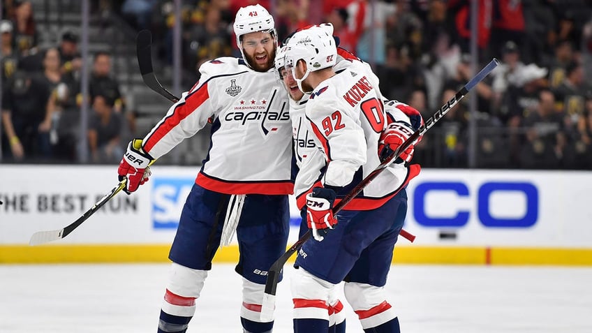 Evgeny Kuznetsov celebrates with teammates