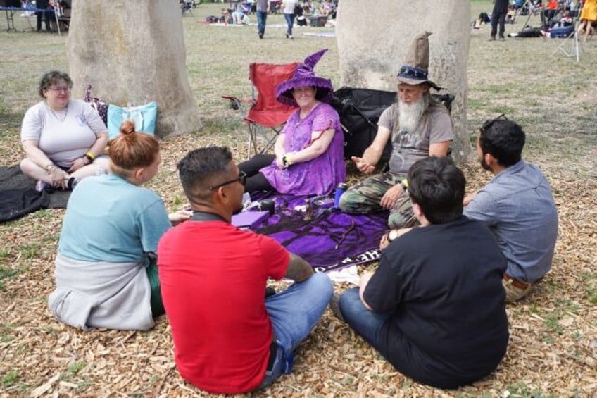 People gather to watch a total solar eclipse across North America, at Stonehenge II at the