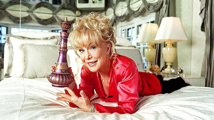 Barbara Eden holding her genie bottle