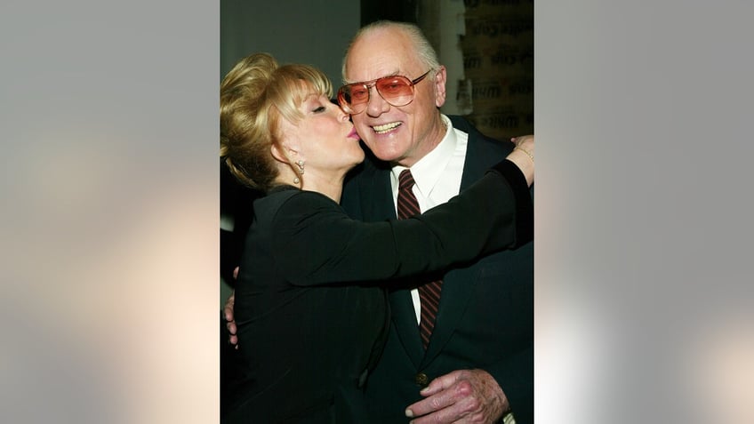 Barbara Eden kissing Larry Hagman.