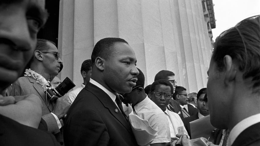 Dr. Martin Luther King Jr., holding his speech close to his chest, speaks to reporters at the Lincoln Memorial on Aug. 28, 1963. (Bob Parent/Getty Images)